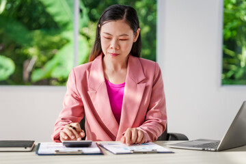 40-year-old middle-aged Asian businesswoman wearing pink suit, business finance, investment...