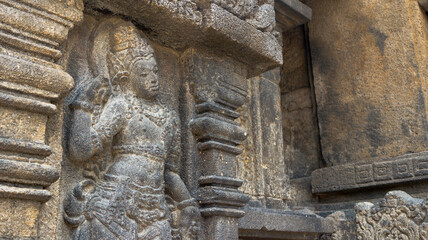 Intricate reliefs of Prambanan Temple, showcasing ancient Javanese artistry and Hindu mythology. Detailed stone carvings depict scenes of gods, heroes, and legends, reflecting Indonesia's rich culture