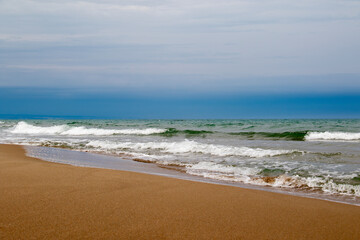 beach with sand and shells, footprints in the sand