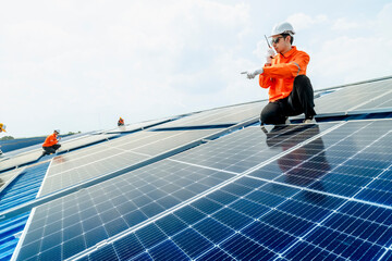 engineer man inspects construction of solar cell panel or photovoltaic cell by electronic device....