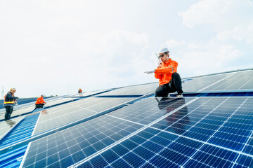 engineer man inspects construction of solar cell panel or photovoltaic cell by electronic device. Industrial Renewable energy of green power. factory worker working on tower roof.