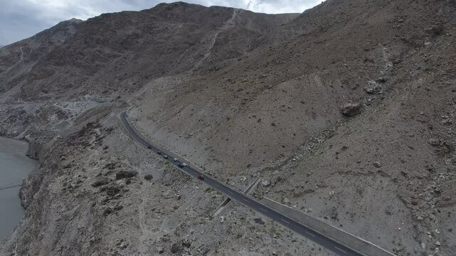 Aerial view of Karakoram Highway winding through remote, rocky mountains, Punjab, Pakistan.