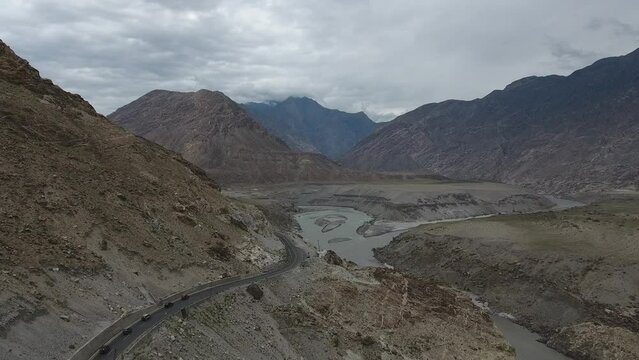 Aerial view of winding road and majestic mountains along Karakoram Highway, Punjab, Pakistan.