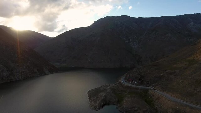 Aerial view of serene sunset over majestic lake and rugged mountains, Kaghan Valley, Mansehra District, Pakistan.