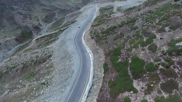 Aerial view of winding mountain road through remote rocky terrain, Kaghan Valley, Pakistan.