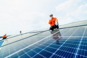 engineer man inspects construction of solar cell panel or photovoltaic cell by electronic device....