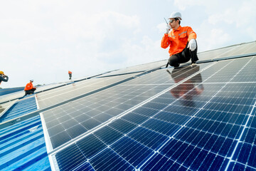 engineer man inspects construction of solar cell panel or photovoltaic cell by electronic device. Industrial Renewable energy of green power. factory worker working on tower roof.