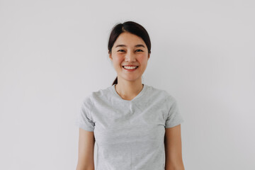 Happy asian woman smiling look at camera, isolated over white background wall.