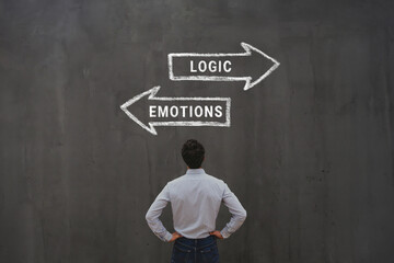 Logic vs emotions, logical choice versus emotional, business man looking at arrows