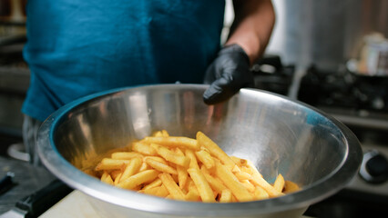 Adding Salt On The Crispy Fried Potatoes