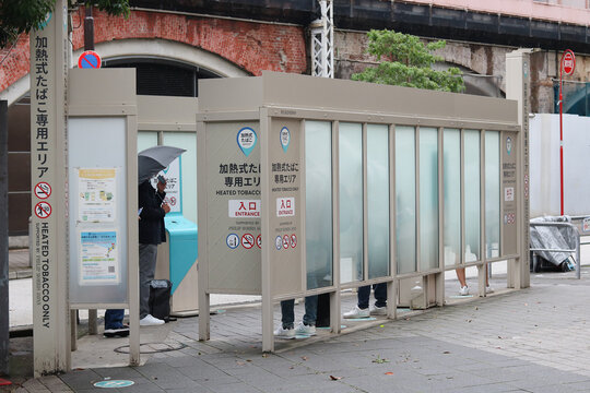TOKYO, JAPAN - June 23, 2024: A designated smoking area on a street in Tokyo's Shimbashi area which is for heated tobacco products only.
