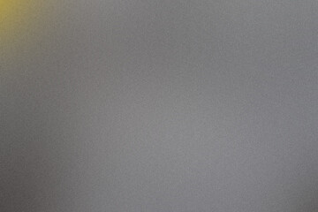 Grainy gray background featuring a gradient with a fading yellow light in the top left corner