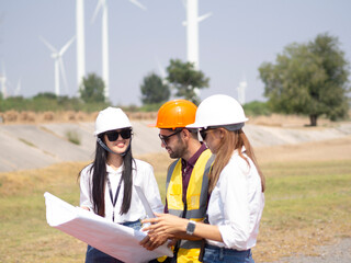 A group of engineers and architects are consulting. About taking care of wind turbines For a sustainable environment