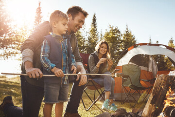 Family, camping and smores outdoor with smile for bonding with love, nature and relax in forest with affection. Mother, father and son together for adventure in wilderness, peace and summer trip.