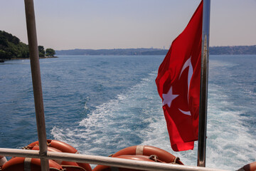 Turkish flag, on a red background white star and moon. Turkish flag flies in the wind.