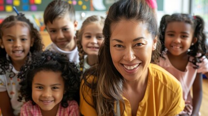 caring female kindergarten teacher smiling at camera with group of diverse young students