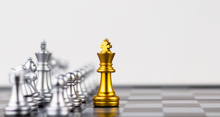 Leader, business strategy and planning concept, Gold Chess king figure on Chessboard and surrounded by a number of fallen silver chess pieces against opponent or enemy. Conflict, tactic, politic.
