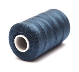 Full cross-wound spool of thin sewing tread isolated on white background