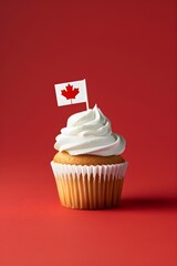 Cupcake with little Canadian flag. Sweet dessert for holiday party on red background. Happy Canada day. Victoria Day, Independence Day. Festive backdrop for greeting card, banner, poster. Copy space