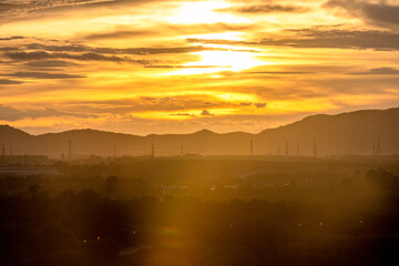 Background of trees growing along the sea coast, rain clouds covering and wind blowing blurred during the rainy season at the Noen Nang Phaya viewpoint, Chanthaburi, Thailand.