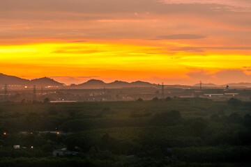 Background of trees growing along the sea coast, rain clouds covering and wind blowing blurred during the rainy season at the Noen Nang Phaya viewpoint, Chanthaburi, Thailand.