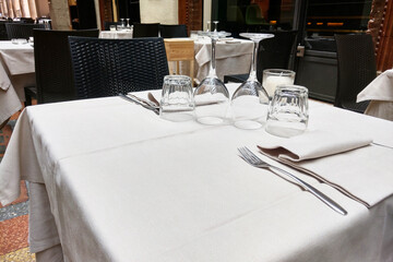 Elegant Outdoor Dining Table Setting with Glassware and Silverware in Urban Restaurant - Perfect for Date Nights and Special Occasions