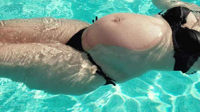 pregnant woman belly in the pool