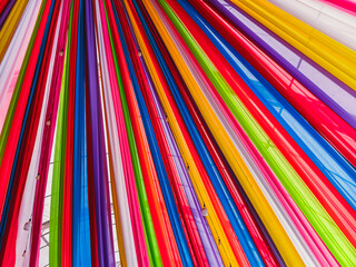 Rainbow cloth roof. Abstract image of tent roof fabricated from multicolored fabric. Colorful fabric in the festival. Multicolored backgrounds from fabrics of different colors, textured with patterns.