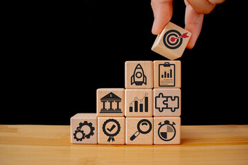 Business goal, plan. wooden cubes with icon business strategies, action plan, goal, process, game...