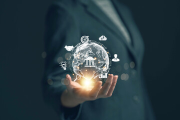 Businessman holds virtual globe in hand with business icons Application technology for internet connection around the world and digital marketing Market link technology, big data tools, finance