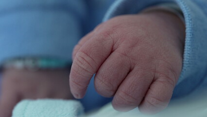 Close-up of newborn baby hand in macro detail during initial days of life. Beautiful body detail of...