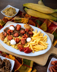 Colombian picada with pulled beef, pulled chicken, fried pork skin, cheese, quail eggs, chorizo