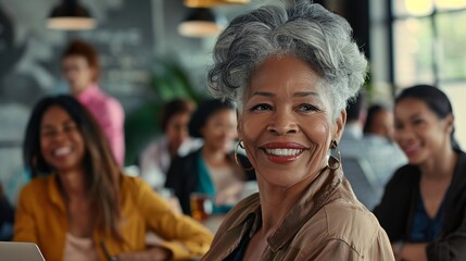 Senior black woman with diverse team in creative office.