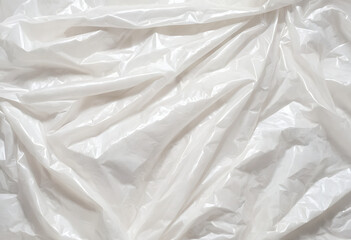 Obraz premium Crinkled clear plastic sheet with light reflecting off its surface.