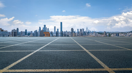 Fototapeta premium Urban Skyline Across Open Parking Lot