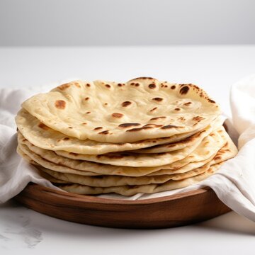 Stack of Freshly Made Rumali Roti Flatbreads on Wooden Plate