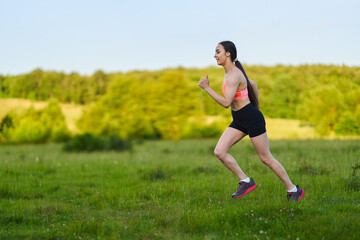 Latin girl running on a trail in the forest