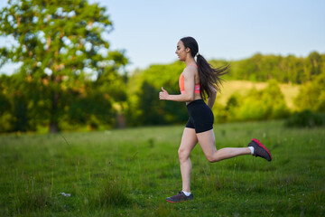 Latin girl running on a trail in the forest