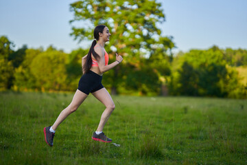 Latin girl running on a trail in the forest