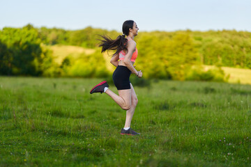 Latin girl running on a trail in the forest