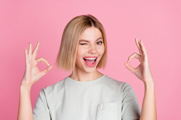 Portrait of positive pretty lovely girl with bob hairstyle wear white t-shirt showing okey winking...