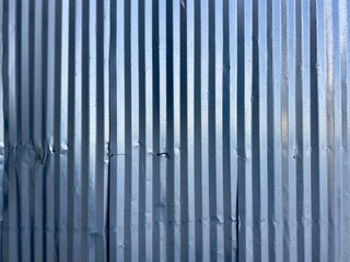 A cargo shipping container wall, robust and industrial, features corrugated metal and secure locks, symbolizing strength and global trade in a practical, utilitarian design.