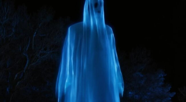 Haunting Glow: Blue Light Ghost on a Halloween Night