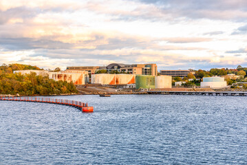 Naklejka premium Rusty fuel tanks in a riverside oil terminal at sunset in autumn