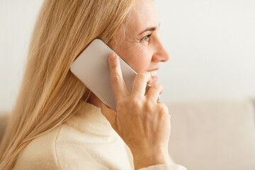 Mature Blond Woman Talking On Phone, Closeup, Side View