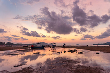 Scenery The sweet sky in sunrise over the fishing port..stunning sunrise at the sea in twilight. .Scene of colorful pink light trough in the dark cloud. Sky texture, abstract nature background