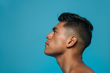 Face of a young Asian man in profile isolated on blue background with copy space. Generative AI.