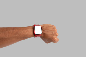 Male hand wearing a red smartwatch isolated on grey background blanc screen