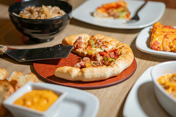 Table with assorted Italian dishes including pizza and pasta