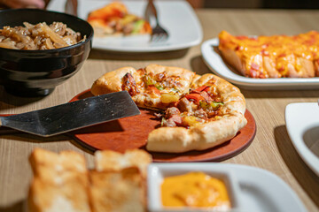 Table with assorted Italian dishes including pizza and pasta
